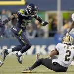 New Orleans Saints quarterback Jameis Winston (2) goes down in front of Seattle Seahawks safety Jamal Adams (33) during an NFL football game against the Seattle Seahawks, Monday, Oct. 25, 2021, in Seattle. (AP Photo/Ted S. Warren)