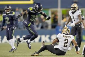 New Orleans Saints quarterback Jameis Winston (2) goes down in front of Seattle Seahawks safety Jamal Adams (33) during an NFL football game against the Seattle Seahawks, Monday, Oct. 25, 2021, in Seattle. (AP Photo/Ted S. Warren)