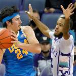 UCLA guard Jaime Jaquez Jr. (24) looks to pass around the defense of Washington guard PJ Fuller during a game Monday in Seattle. (AP Photo/Ted S. Warren)