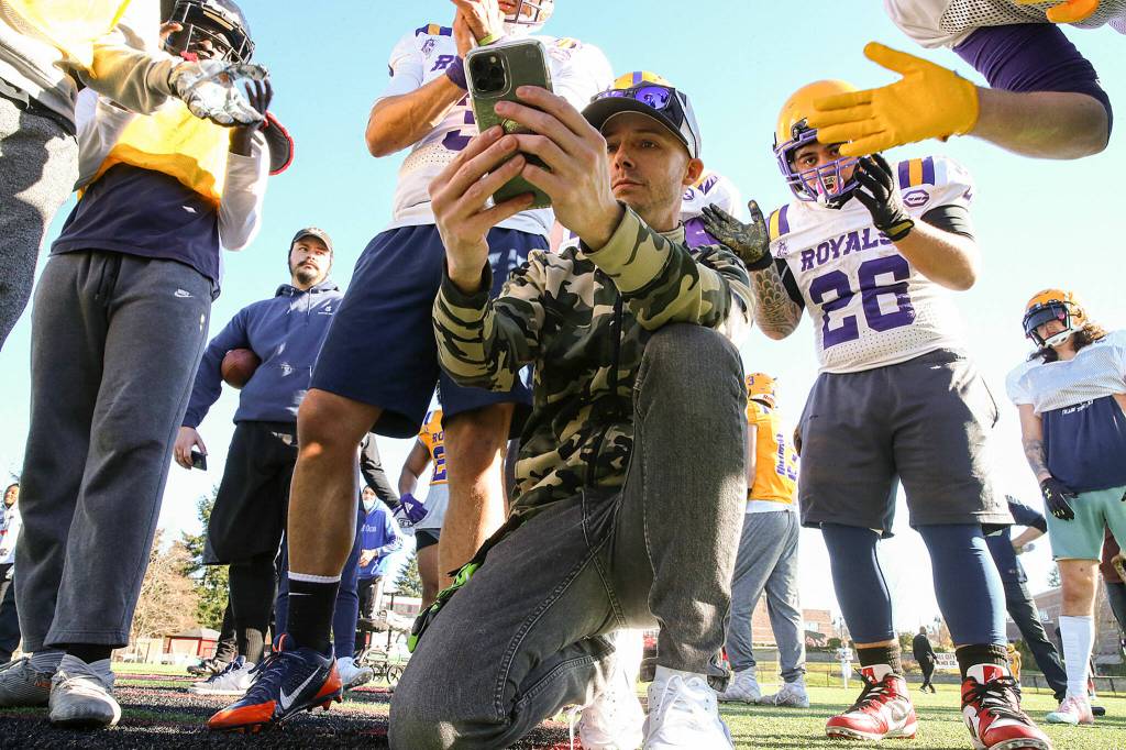 Beau Beery, Everett Royals offensive coordinator, calls a play in the huddle during practice at Archbishop Murphy High School. (Kevin Clark / The Herald)
