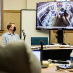 Alejandro Meza watches a video of the altercation he had with Gene Peterson on a Community Transit bus in Everett during opening statements for his trial on Oct. 20. (Olivia Vanni / The Herald)