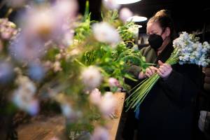 FIELD co-owner Liz Morgan processes flowers at their shop in Edmonds on Wednesday, March 2, 2022. (Olivia Vanni / The Herald)