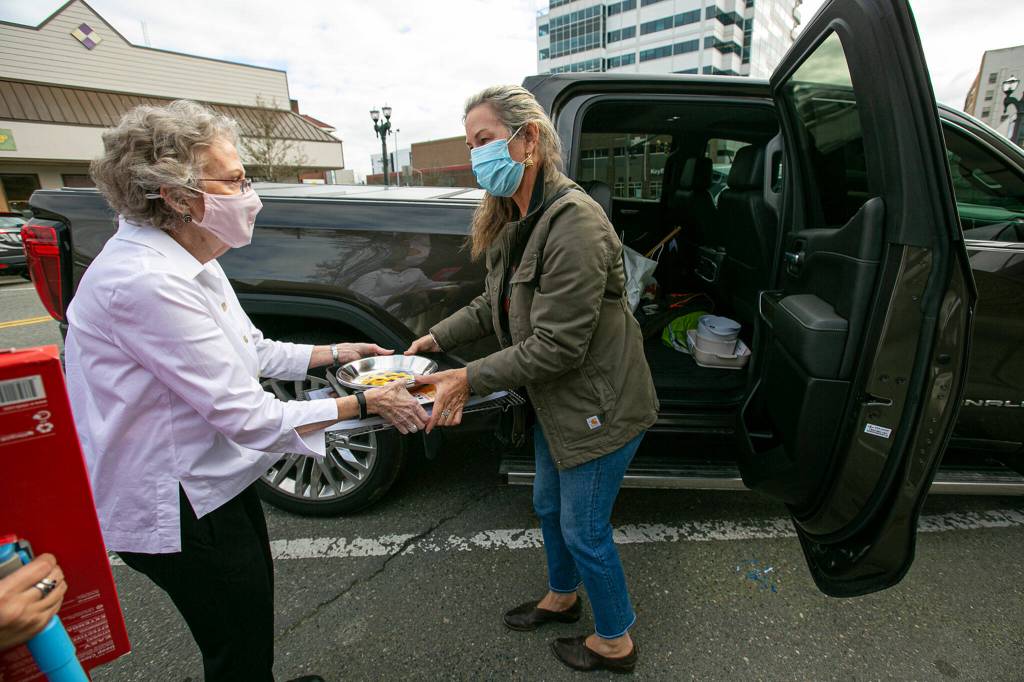 Judy Matheson helps longtime customer Merrilee Moore carry her purchase to her car. I do this a lot, Matheson said. Sometimes we even deliver. (Ryan Berry / The Herald)