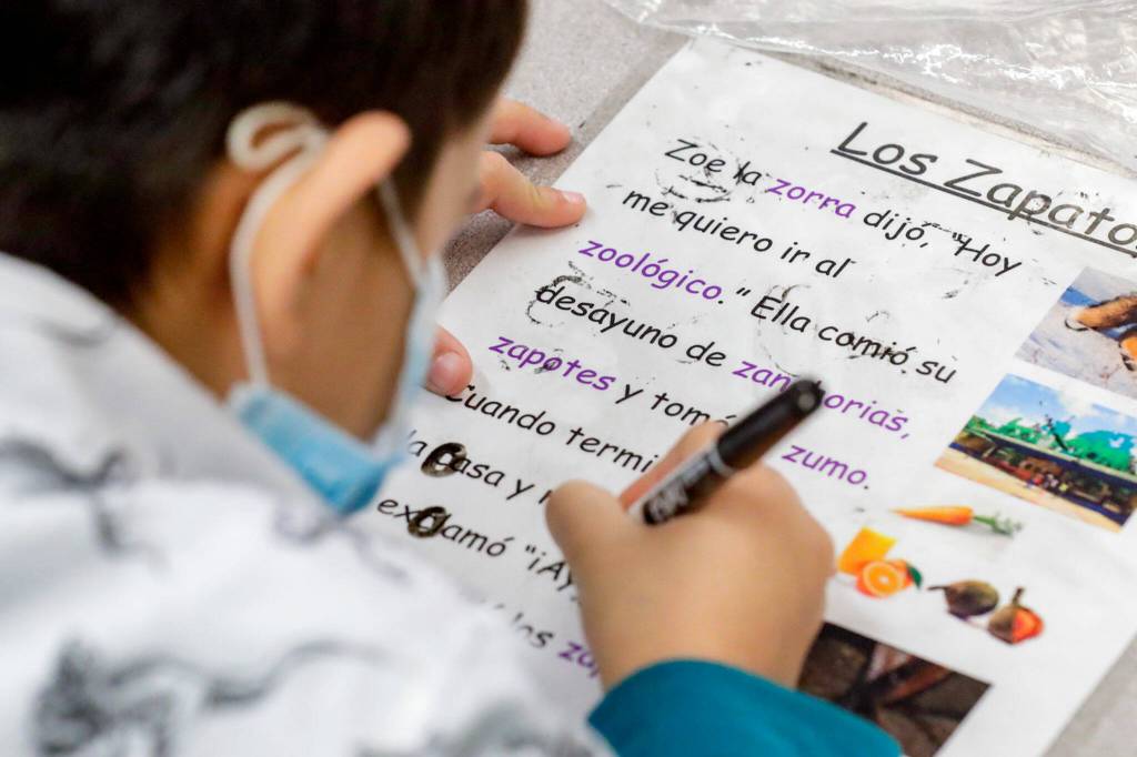A student works through a worksheet at College Place Elementary School in Lynnwood. (Kevin Clark / The Herald)