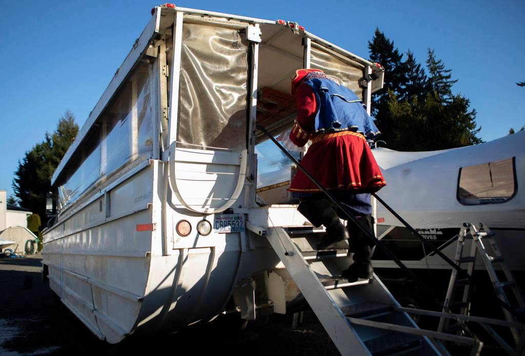 George Safadago, also known as Captain Shipwreck, boards the 1945 DUKW in Mukilteo. (Olivia Vanni / The Herald)
