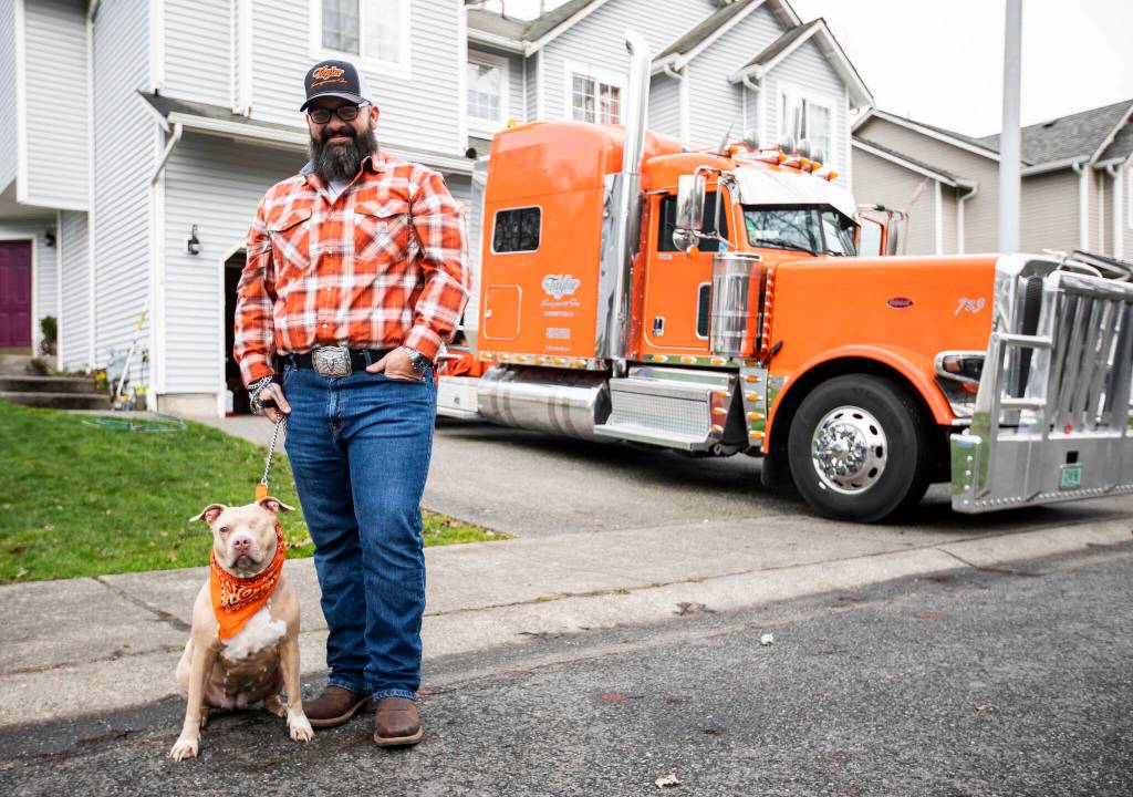 Shawn Stogie Dirksen and his one-eyed pitbull Bonnie and his truck The Orange Crush in Lake Stevens. (Olivia Vanni / The Herald)
