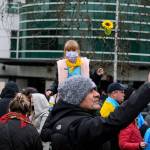 A young child carries a sunflower, the national flower of Ukraine, during a demonstration in Seattle on Saturday. The sunflower became a symbol against Russias invasion after a Ukrainian woman confronted a heavily armed Russian soldier last week. While cursing at the soldier, she offered him seeds so that when he died on Ukrainian soil, at least sunflowers will grow. (Taylor Goebel / The Herald)