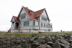 A person walks along a path past the Weyerhaeuser Building on Wednesday, March 2, 2022, at the Port of Everett in Everett, Washington. (Ryan Berry / The Herald)