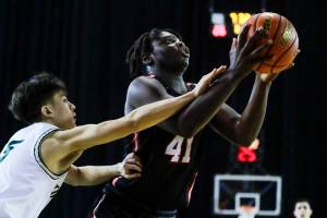 Mountlake Terrace's Zaveon Jones goes for a shot attempt with Timberline's Alex Tichenor trailing Wednesday afternoon in Tacoma, Washington on March 2, 2022. (Kevin Clark / The Herald)