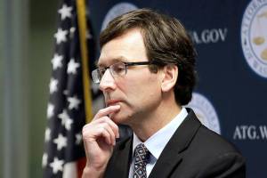 FILE - Washington state Attorney General Bob Ferguson looks on during a news conference in Seattle on Dec. 17, 2019. Ferguson rejected a half-billion-dollar settlement offer, and now he's taking the state's case against the nation's three biggest drug distributors to trial Monday, Nov. 15, 2021. He says they must be held accountable for their role in the opioid crisis. (AP Photo/Elaine Thompson, File)