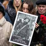 A relative holds photo of a soldier killed defending Donetsk airport in 2014-15 in an armed conflict with Russia-backed separatists during a commemorating ceremony in Kyiv, Ukraine, Jan. 20, 2019. (Ukrainian Presidential Press Office via AP)