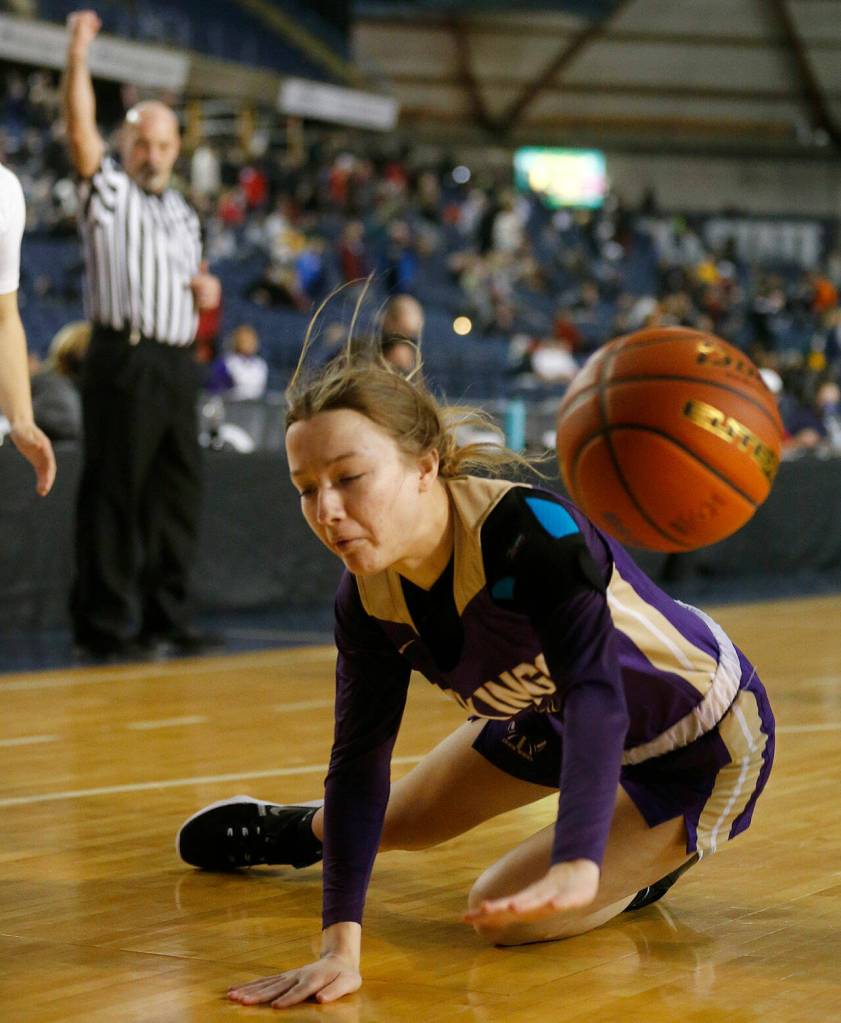 Lake Stevens Ella Edens hits the floor after getting fouled against Pasco on Thursday at the Tacoma Dome. (Ryan Berry / The Herald)