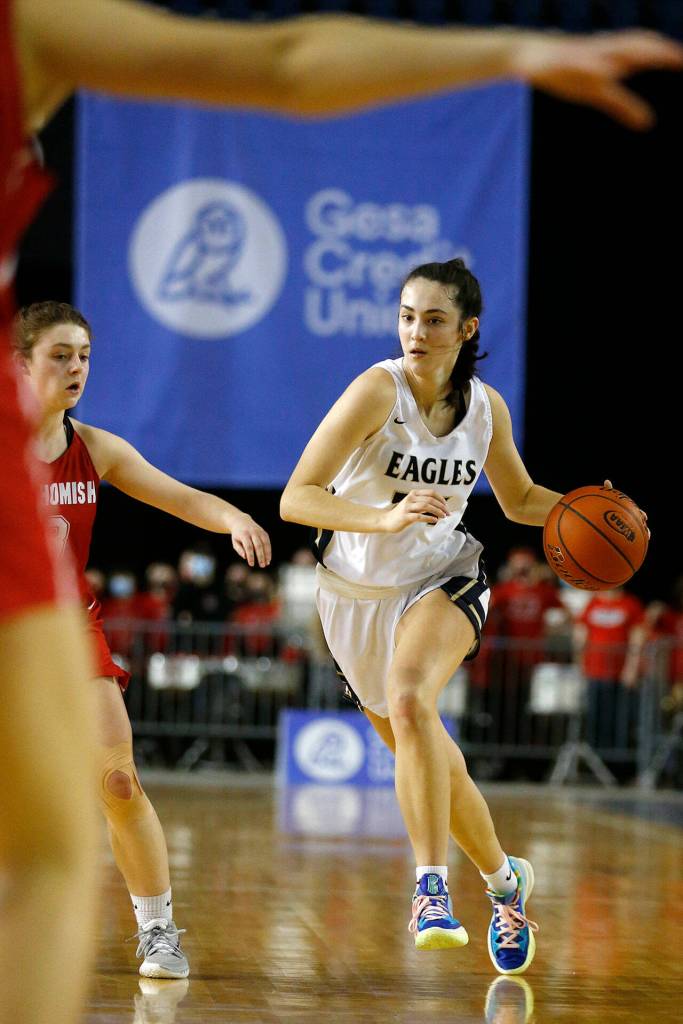 Arlingtons Jenna Villa takes the ball up the court against Snohomish on Thursday at the Tacoma Dome. (Ryan Berry / The Herald)