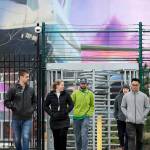 FILE - In this March 23, 2020, file photo, workers head out a gate at a Boeing airplane manufacturing plant, where a mural of a jet covers a massive door behind in Renton, Wash. Boeing Co. has said it will dole out annual performance bonuses next month to most employees despite losing $12 billion over the last year during the coronavirus pandemic. Most of the company's employees did not receive annual bonuses last year after it lost $636 million in 2019 because of the grounding of the 737 MAX by the Federal Aviation Administration, The Seattle Times reported. (AP Photo/Elaine Thompson, File)