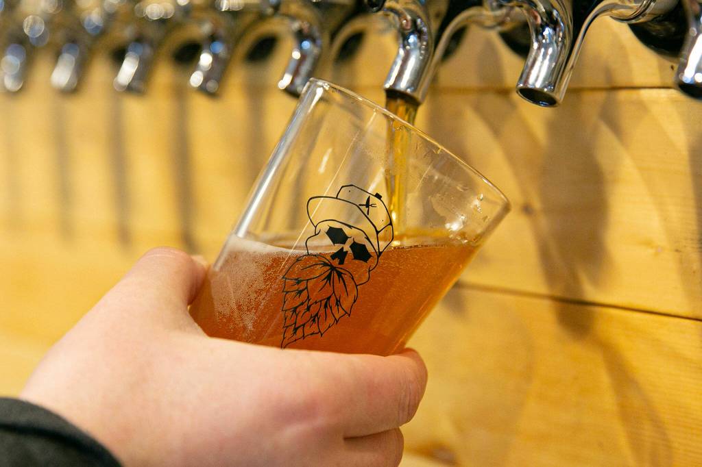 Kory Dyer draws a pint at Meatheads Smokehouse and Beer Works in Lake Stevens. (Ryan Berry / The Herald)