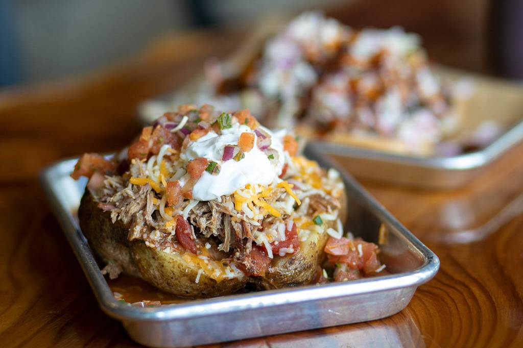 A loaded baked potato at Meatheads Smokehouse and Beer Works. (Ryan Berry / The Herald)