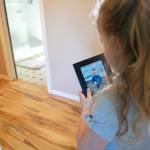 Emalyn Page, 5, walks through the house with a photo of Mykyta as she often does, according to her mother  on Sunday in Snohomish. (Ryan Berry / The Herald)