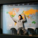 A photo of Mykyta pointing to his two homes, Ukraine and Washington, hangs on the wall outside his bedroom.