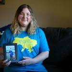 Katie-Jo Page sits in her living room with a photo of Mykyta on Sunday, March 6, 2022, in Snohomish, Washington. (Ryan Berry / The Herald)