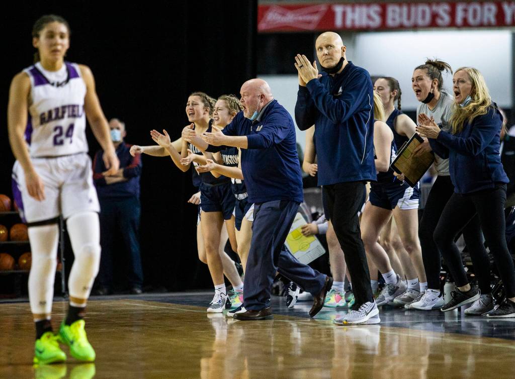 The Arlington bench reacts to pulling ahead of Garfield during the first quarter of the 3A state semifinal at the Tacoma Dome on Friday, March 4, 2022. (Olivia Vanni / The Herald)