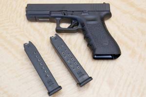 FILE - In this Tuesday, June 27, 2017, file photo, a semi-automatic hand gun is displayed with a 10 shot magazine, left, and a 15 shot magazine, right, at a gun store in Elk Grove, Calif. A three-judge panel of the 9th U.S. Circuit Court of Appeals has thrown out California's ban on high-capacity ammunition magazines. The panel's majority ruled Friday, Aug. 14, 2020, that the law banning magazines holding more than 10 bullets violates the constitutional right to bear firearms. (AP Photo/Rich Pedroncelli, File)