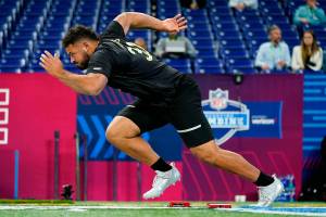 Washington State offensive lineman Abraham Lucas runs the 40-yard dash at the NFL football scouting combine in Indianapolis, Friday, March 4, 2022. (AP Photo/Charlie Neibergall)