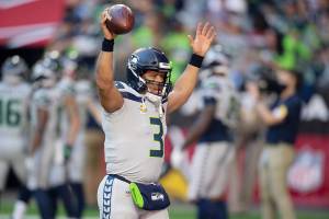 Seattle Seahawks quarterback Russell Wilson (3) raises his hands to the crowd before playing the Arizona Cardinals during an NFL Professional Football Game Sunday, Jan. 9, 2022, in Phoenix. (AP Photo/John McCoy)