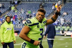 Seattle Seahawks quarterback Russell Wilson waves to fans as he leaves the field after an NFL football game against the Los Angeles Rams, Thursday, Oct. 7, 2021, in Seattle. Wilson suffered a hand injury and the Rams won 26-17. (AP Photo/Elaine Thompson)