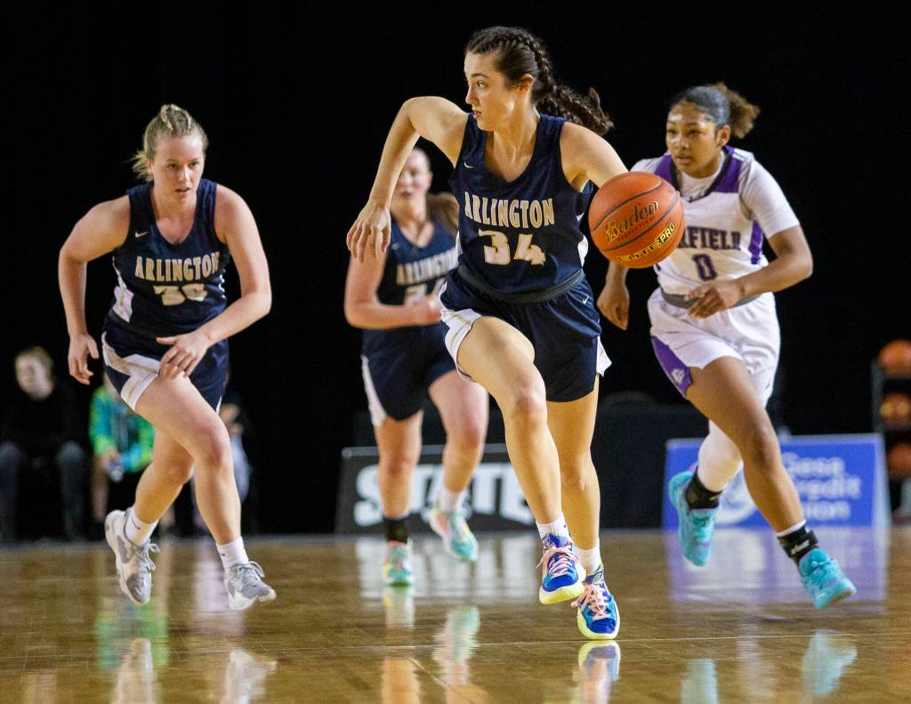 Arlingtons Jenna Villa looks for an open teammate after stealing the ball during Class 3A Hardwood Classic semifinal game against Garfield on March 4 in Tacoma. (Olivia Vanni / The Herald)