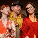 Rosalind_Celia_Touchstone: Touchstone the jester (played by Jay Rairigh, center) helps Rosalind (Kris Hambrick, left) and Celia (Sydney Kaser, right) develop a plan to test Orlando’s vows of love in Red Curtain’s production of As You Like It, running March 11-27 at the Red Curtain Arts Center, 9315 State Ave. in Marysville.