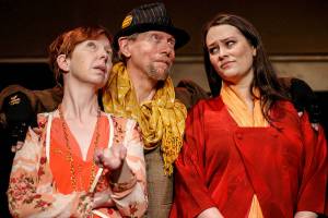 Rosalind_Celia_Touchstone: Touchstone the jester (played by Jay Rairigh, center) helps Rosalind (Kris Hambrick, left) and Celia (Sydney Kaser, right) develop a plan to test Orlando’s vows of love in Red Curtain’s production of As You Like It, running March 11-27 at the Red Curtain Arts Center, 9315 State Ave. in Marysville.