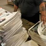 An employee sorts newspapers for delivery at a distribution center in Liberty Township near Youngstown, Ohio, on Aug. 6, 2019. (Tony Dejak / Associated Press file photo)