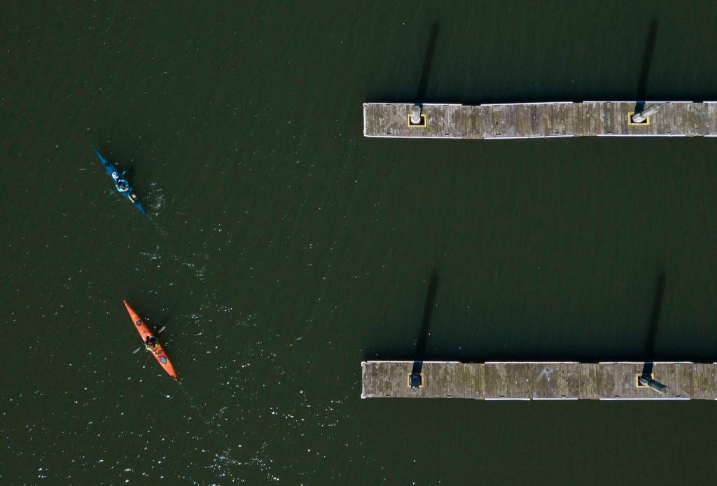 Amanda Sharples and April Emmett kayak out of the Tenth St. Boat Launch as they make their way to Jetty Island on Wednesday in Everett. (Olivia Vanni / The Herald)