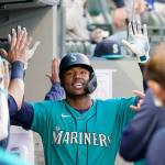 Seattle Mariners Kyle Lewis is congratulated after his two-run home run against the Texas Rangers in the third inning of a game May 28, 2021, in Seattle. (AP Photo/Elaine Thompson)