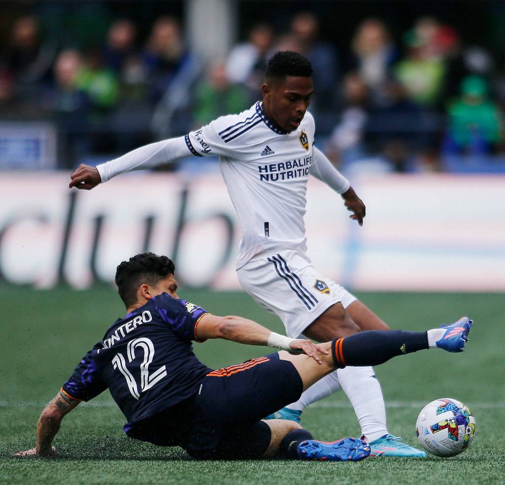 The Seattle Sounders Fredy Montero slide tackles to try to gain possession of the ball against the Los Angeles Galaxy Saturday, March 12, 2022, at Lumen Field in Seattle, Washington. (Ryan Berry / The Herald)
