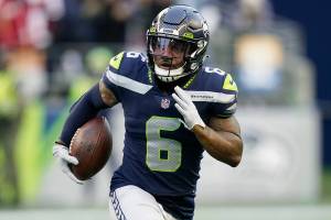 Seattle Seahawks free safety Quandre Diggs runs with the ball after he intercepted a pass against the San Francisco 49ers during the second half of an NFL football game, Sunday, Dec. 5, 2021, in Seattle. (AP Photo/Elaine Thompson)