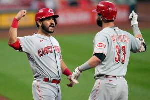 Cincinnati Reds' Jesse Winker (33) is congratulated by teammate Eugenio Suarez after hitting a two-run home run during the second inning of a baseball game against the St. Louis Cardinals Thursday, June 3, 2021, in St. Louis. (AP Photo/Jeff Roberson)