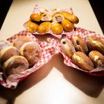 An assortment of sugar-covered-and-filled malasadas and sausage-filled kolaches. (Olivia Vanni / The Herald)
