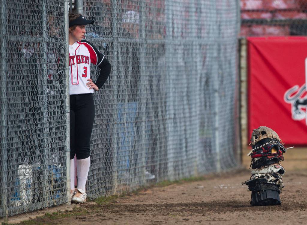 Snohomishs Kendel Sage looks out from the dugout before the start ofvthe game against Glacier Peak on Wednesday, March 16, 2022 in Snohomish, Washington. (Olivia Vanni / The Herald)