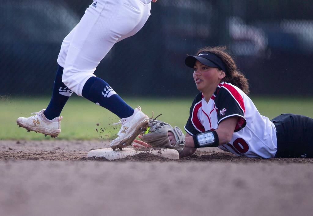 Snohomishs Emma Hansen dives to try and beat the runner to second base during the game against Glacier Peak on Wednesday, March 16, 2022 in Snohomish, Washington. (Olivia Vanni / The Herald)