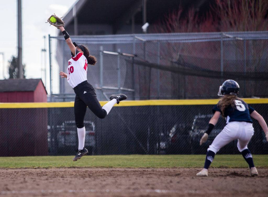 Snohomishs Emma Hansen makes a leaping catch during the game against Glacier Peak on Wednesday, March 16, 2022 in Snohomish, Washington. (Olivia Vanni / The Herald)