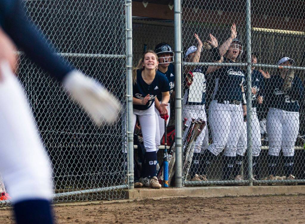 The Glacier Peak dugout cheers on their teammate during the game against Snohomish on Wednesday, March 16, 2022 in Snohomish, Washington. (Olivia Vanni / The Herald)