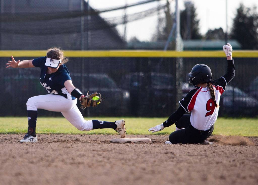 Glacier Peaks Katelyn McCallum reaches to make catch to get Snohomishs Avery Clark out at second during the game on Wednesday, March 16, 2022 in Snohomish, Washington. (Olivia Vanni / The Herald)