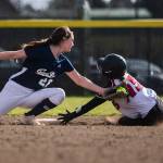 Glacier Peak’s Lauren Hufford tags out Snohomish’s Camryn Sage as she slides into second base during the game on Wednesday, March 16, 2022 in Snohomish, Washington. (Olivia Vanni / The Herald)