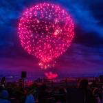 People gather to watch the Thunder on the Bay Fireworks from Legion Memorial Park on Wednesday, July 4, 2018 in Everett, Washington. (Olivia Vanni / The Herald)