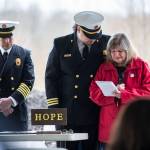 Gail Thompson is comforted by Chaplin Joel Johnson while she reads a speech she wrote earlier in the morning at the Oso Memorial on Tuesday in Oso. (Olivia Vanni / The Herald)