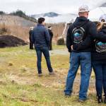 People take a moment of silence at 10:37 a.m. at the Oso Memorial on Tuesday in Oso. (Olivia Vanni / The Herald)