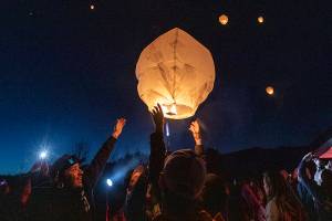 Family members of those lost in the Oso mudslide along with survivors release lanterns into the sky at the memorial site on the 8 year anniversary of the mudslide on Tuesday, March 22, 2022 in Oso, Washington. (Olivia Vanni / The Herald)