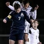 Arlingtons Cameron Mooring, front, and Monroes Rafael Garnica jump for a header Friday evening at Arlington High School in Arlington, Washington on March 18, 2022. (Kevin Clark / The Herald)