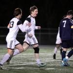 Monroes Owen Skurdal, center, celebrates a goal with Monroes Joshua Gunter, left, Friday evening at Arlington High School in Arlington, Washington on March 18, 2022. (Kevin Clark / The Herald)